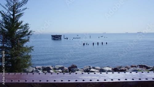 Remnants of Abandoned Pier Over Calm Blue Ocean