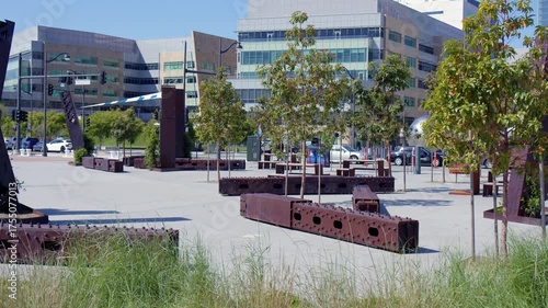 Modern Urban Plaza with Trees and Brick Benches on Sunny Day
