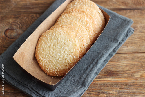 Sesame cookies in a box on a wooden table