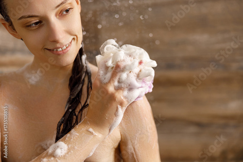 An incredibly enjoyable and relaxing moment in the shower, showcasing a woman applying rich, luxurious soap lather