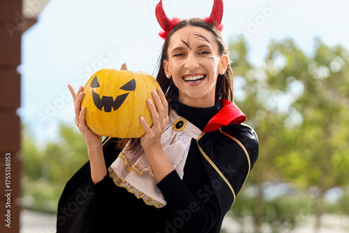 Smiling woman in devil cost...