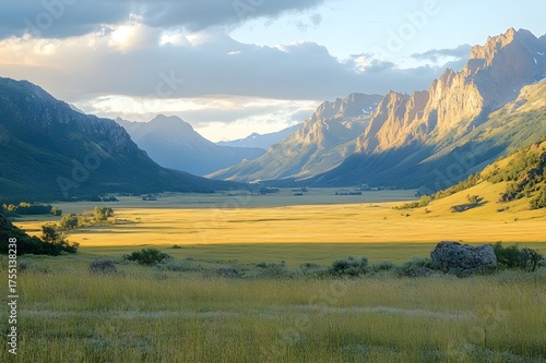 Wide alpine valley with soft light and distant peaks across open meadows