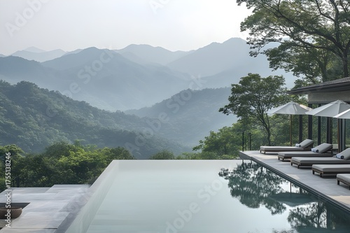 Forest view from tranquil infinity pool with umbrellas and misty ridges