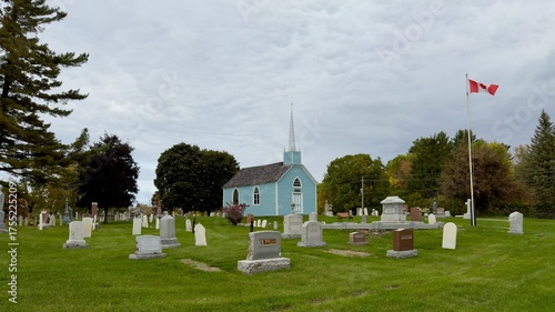A blue church in a fall setting