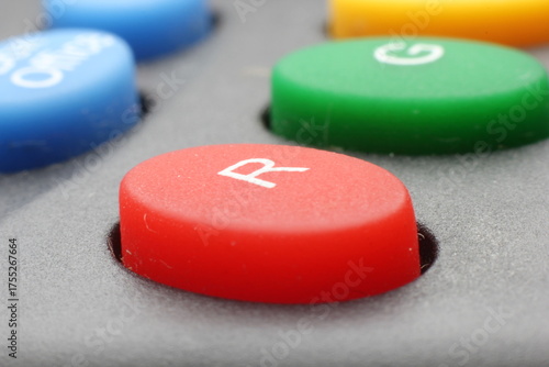 These are control buttons, such as those commonly found on industrial control boards or game consoles. This image shows a red push button marked with the letter 'R'.