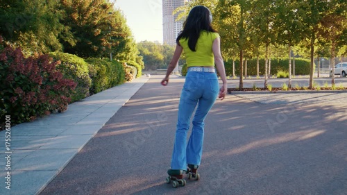 Woman rides forward on roller skates along path with balance