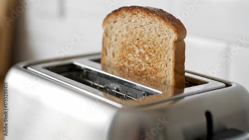 Toasted bread in silver toaster culinary appliance and food preparation