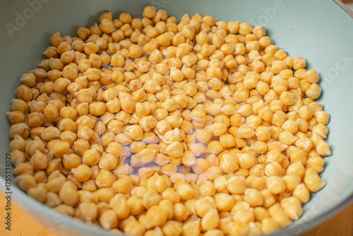 Photograph of chickpeas grown and hydrated with water in a bowl with natural light