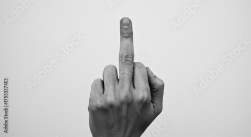 Monochrome image of a hand gesture with the middle finger raised in defiance