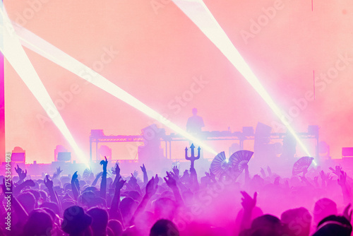 Fans with Arms Waving and Fans in the Crowd at an EDM Dance Music Concert Festival Show