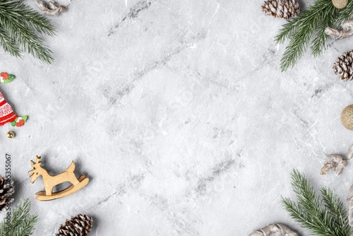 Christmas Background with Pine Branches, Cones and Decorations on Marble Texture.