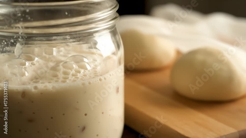 Active Sourdough Starter in Jar, With Dough Balls on Cutting Board