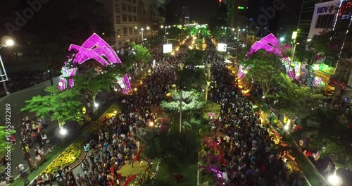 Vibrant Ho Chi Minh City Festival Night with Crowds and Illuminated Arches