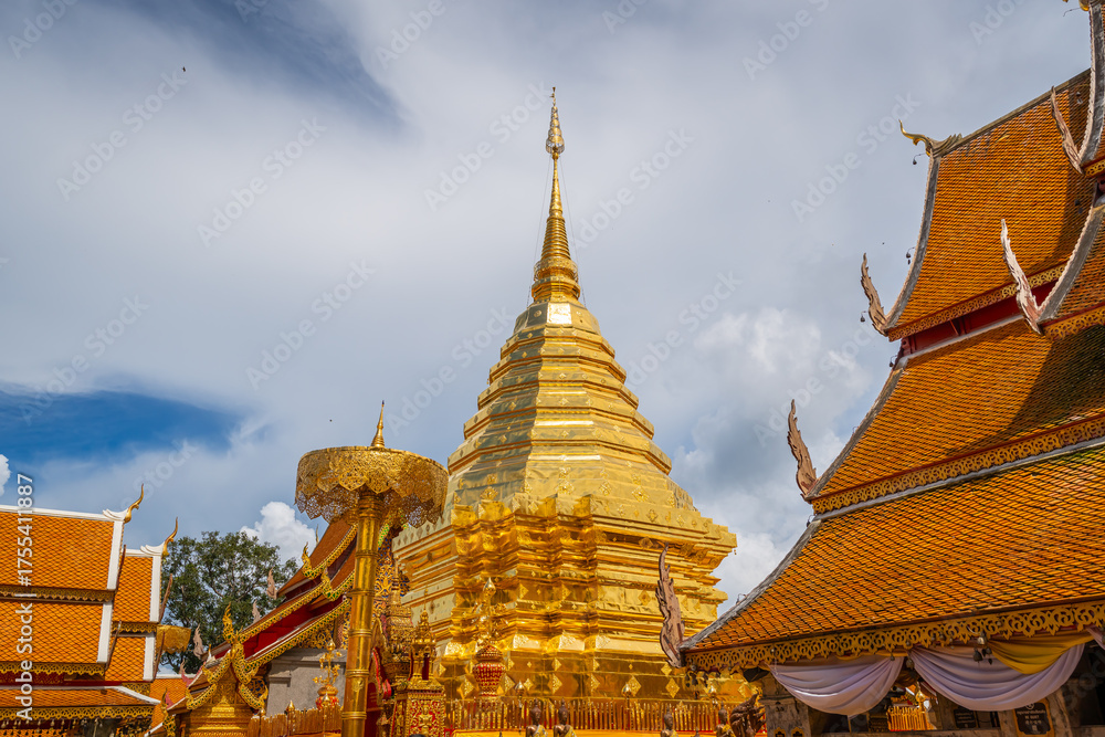 Fototapeta premium The golden stupa of Wat Phra That Doi Suthep shines under the clear blue sky, a sacred symbol of Chiang Mai’s timeless beauty.