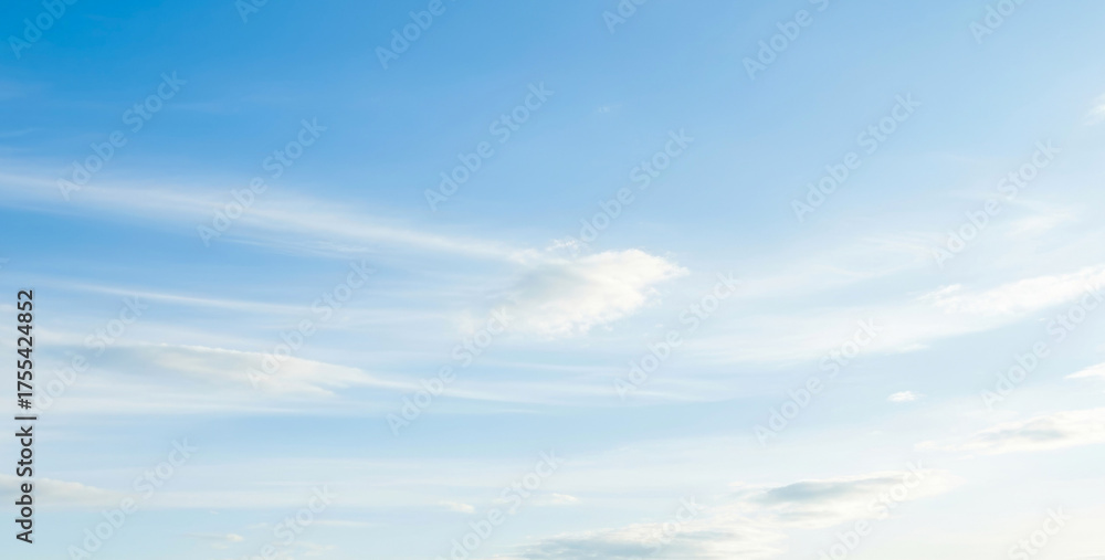 Fototapeta premium Blue sky with soft white clouds creating a peaceful and airy atmosphere, symbolizing freshness, positivity, and an open calm space ideal for design and relaxation.