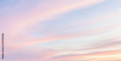 Soft pastel colored sky with clouds in shades of pink, purple, and blue glowing beautifully during twilight, creating a dreamy and artistic color harmony.