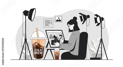 Photographer retouching images on a computer with cold brew coffee drinks nearby