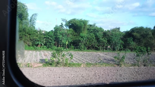 view of farmland from a moving train