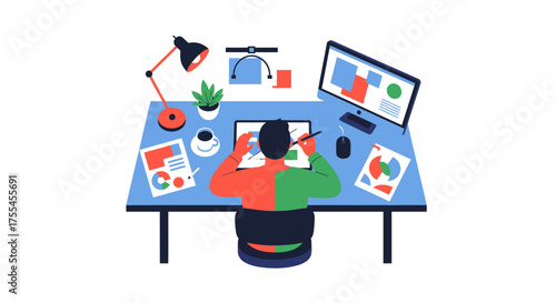 Graphic designer working on a digital tablet at a desk with a computer.