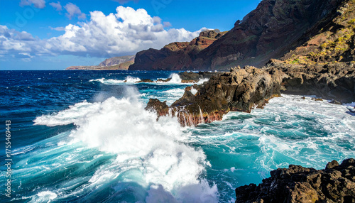 Dramatic ocean waves crashing against rocky coastline in Tenerife Canary Islands.