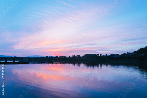 Sunset over River Skyline – Tranquil Cityscape Photography
