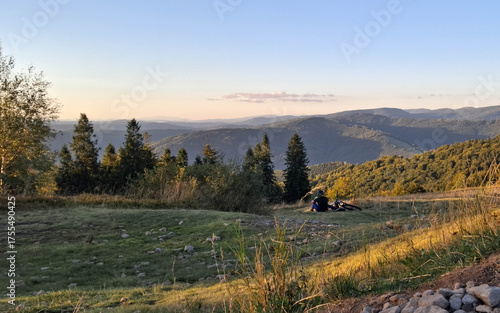 Fototapeta Naklejka Na Ścianę i Meble -  Biker relaxing on a meadow in Beskids.