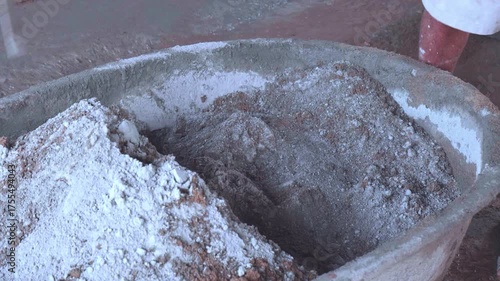 Professional workers are preparing and mixing cement.