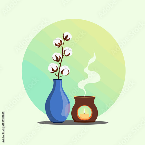 Aesthetic still life featuring a blue vase with cotton branches and a lit aromatherapy diffuser emitting steam.