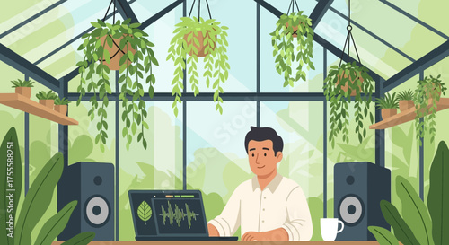 A digital artist working in a greenhouse studio surrounded by lush greenery