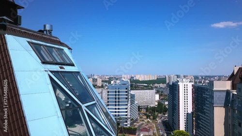 Drone flying over the roofs of houses on a summer day.