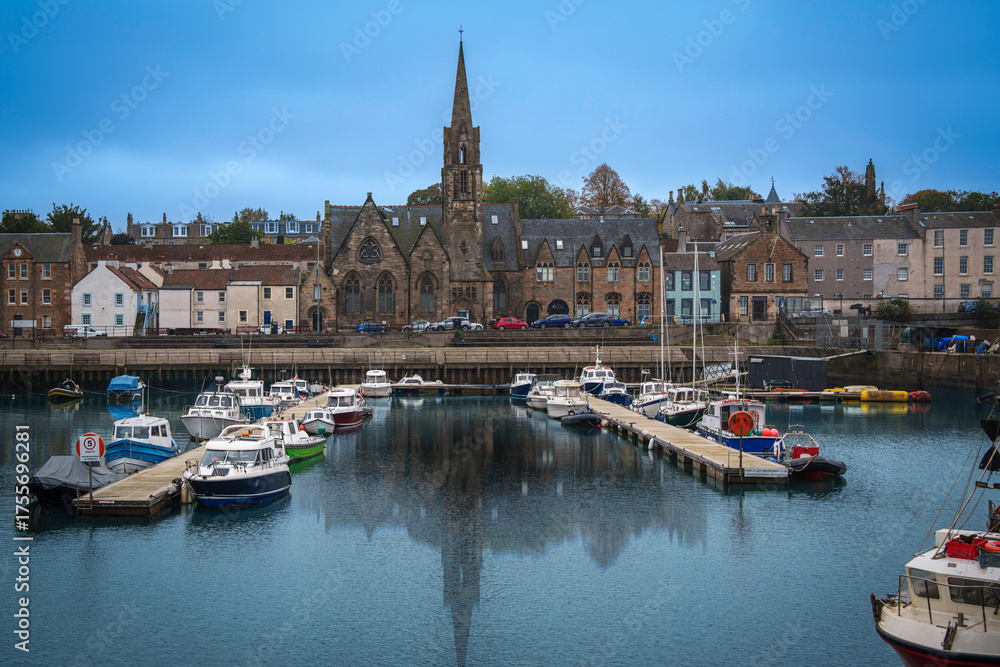 Fototapeta premium Leith skyline and seascape with church spire rising over the Entrance Basin on the North Sea in Scotland.