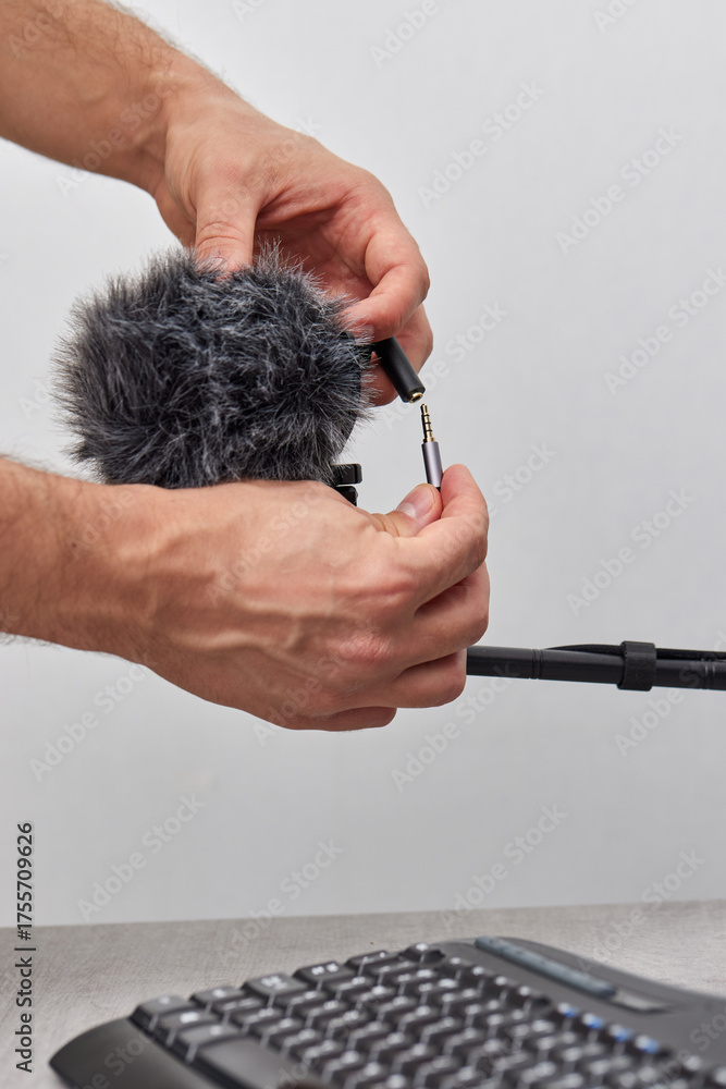 Obraz premium man setting up professional microphone on table at home