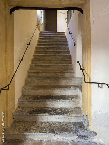 Old, Worn Stone Staircase with Metal Railings in an Historic Building