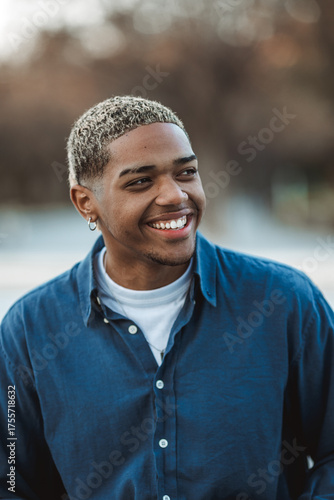 Portrait of a smiling young man looking away with blurred background