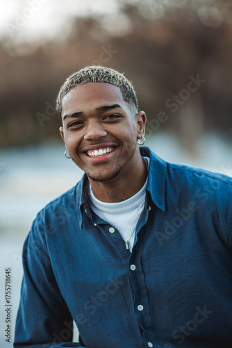 Portrait of black man with cheerful and smiling attitude looking at camera with blurred background