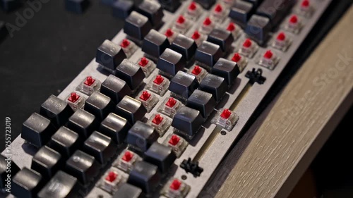 Time lapse video showing man assembling mechanical keyboard, installing keycaps on red switches. Concept of DIY, electronics repair, and computer hardware maintenance