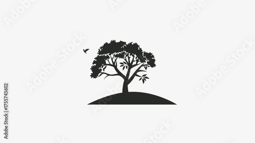 Silhouette of a leafy tree on a mound with a small bird flying nearby