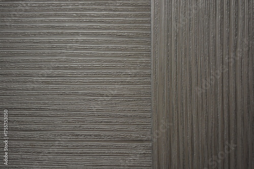 Construction and renovation materials, natural wood background. Gray-brown plastic surface with the texture and relief of wooden planks.