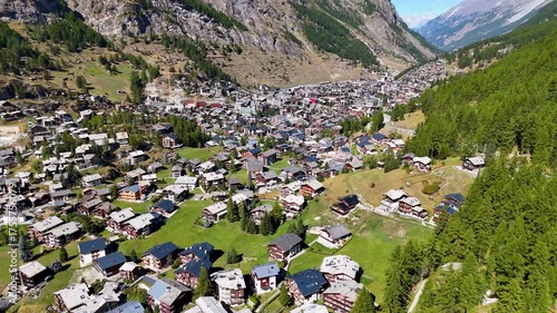 Aerial Pan shoot of the town of Zermatt midday in the Swiss alps

