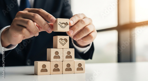 Professional businessman building trust and partnership with wooden blocks symbolizing teamwork and strong relationships in modern office