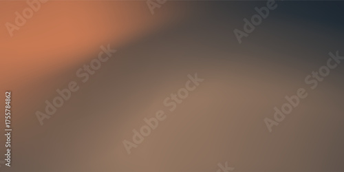 Soft focus sun setting over the ocean glowing orange with dark blue background disign