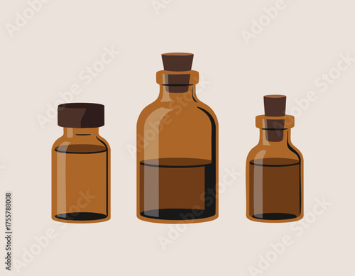 Three brown glass bottles with dark stoppers partially filled with liquid are lined up against a light background