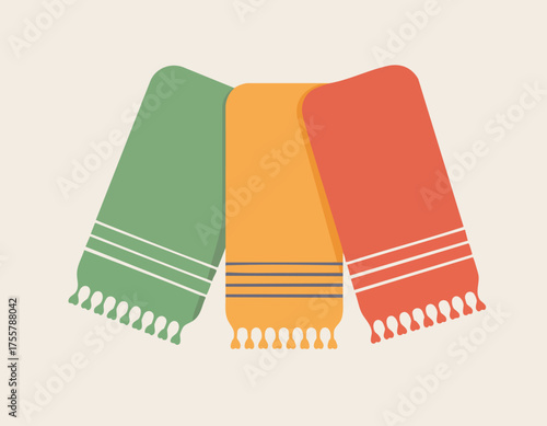 Three folded towels green yellow and red each with tassels and stripes set on beige background