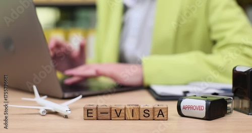 Crafting travel dreams with e-visa approval at a cozy desk in a colorful workspace