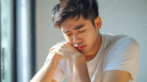 Serious young man feeling stressed and pressured by problems