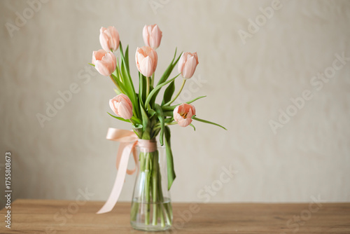 Wallpaper Mural A bouquet of delicate pink tulips in a glass vase on a wooden table, copy space. Torontodigital.ca
