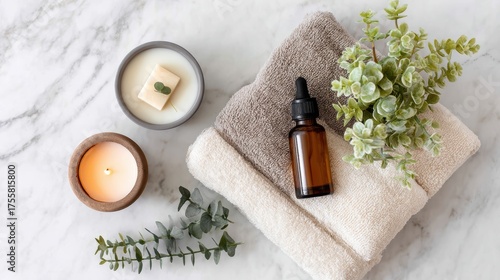 Cozy Spa Setting with Soft Towels, Fragrant Candles, and Essential Oil on Marble Surface