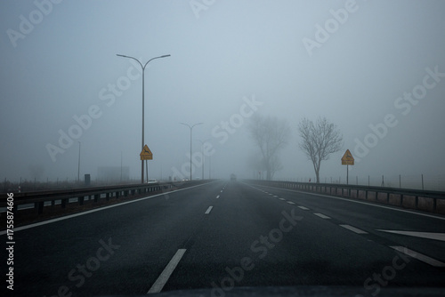 Driving in foggy weather on the highway. Driving in autumn and winter weather.