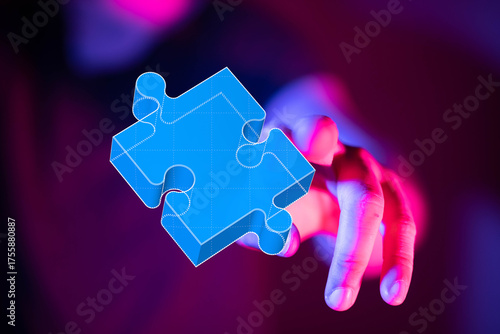 Hand grasping a puzzle piec...