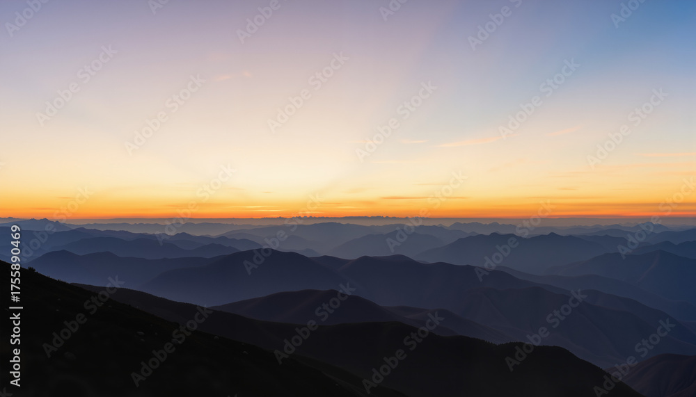 Fototapeta premium Sunrise over mountainous landscape with layers of hills and valleys 